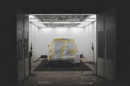 Industrial spray booth with proper lighting, ventilation, and climate control for achieving flawless finishes.